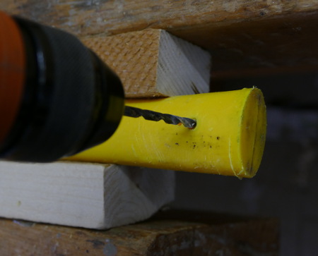 Drill a small fixing bore, so your screw can tightly fix the handle to the axe head.