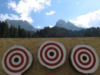Knife throwing targets and mountain view.